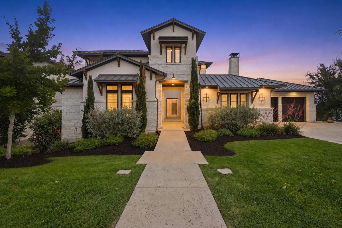 View 508 Woodside TER in Rough Hollow 508 Woodside TER - front exterior with twilight curb appeal - Luxury home in Rough Hollow, Lakeway, TX