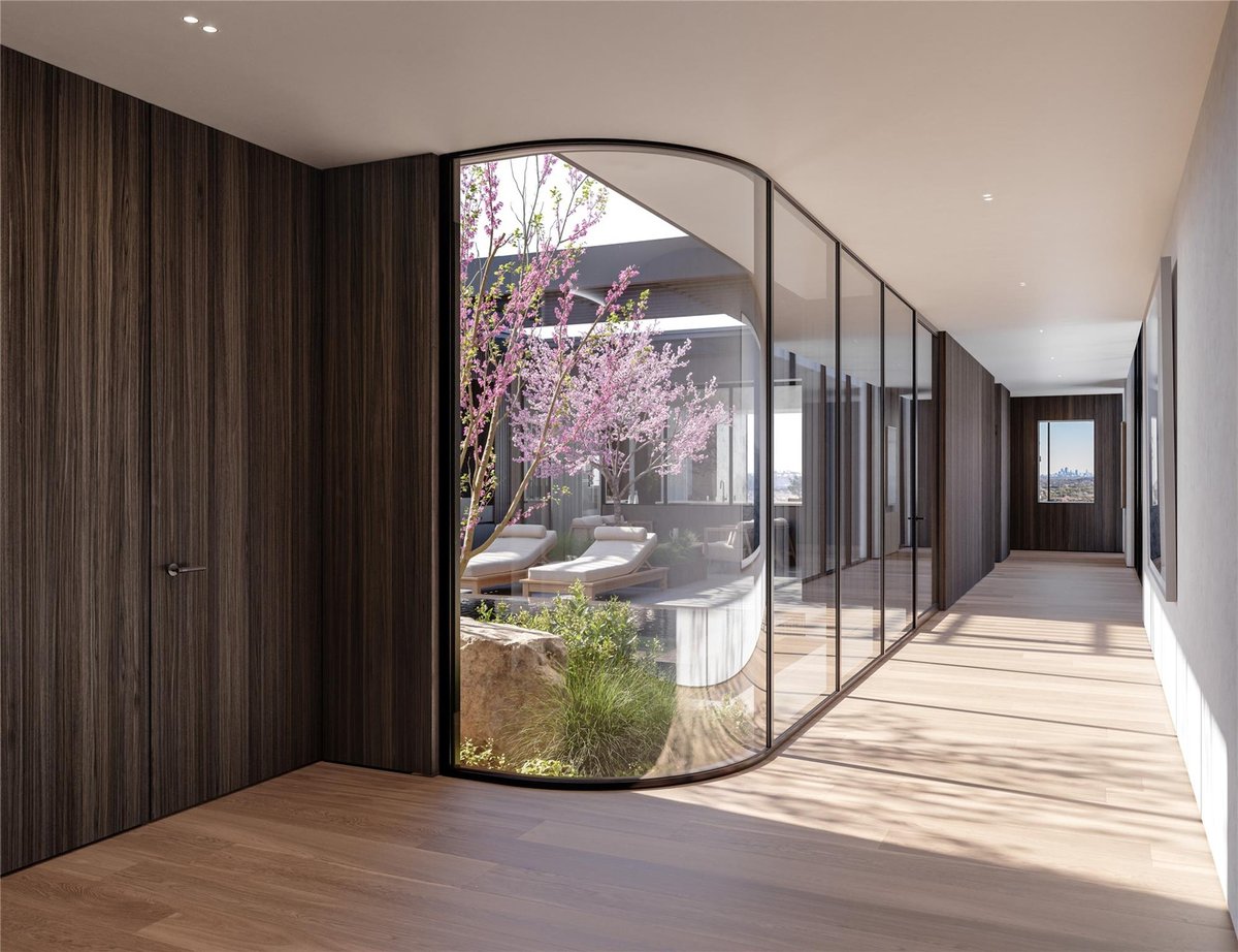 Patio with curved glass wall system with black meta at 6507  Bridge Point Pkwy  #Lot 4 - 4 bed 4 bath home