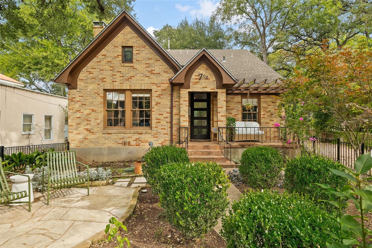 View 708 Sparks Ave in Harris Park Add 708 Sparks Ave - front exterior with classic brick facade and arched entry - Luxury home in Harris Park Add, Austin, TX
