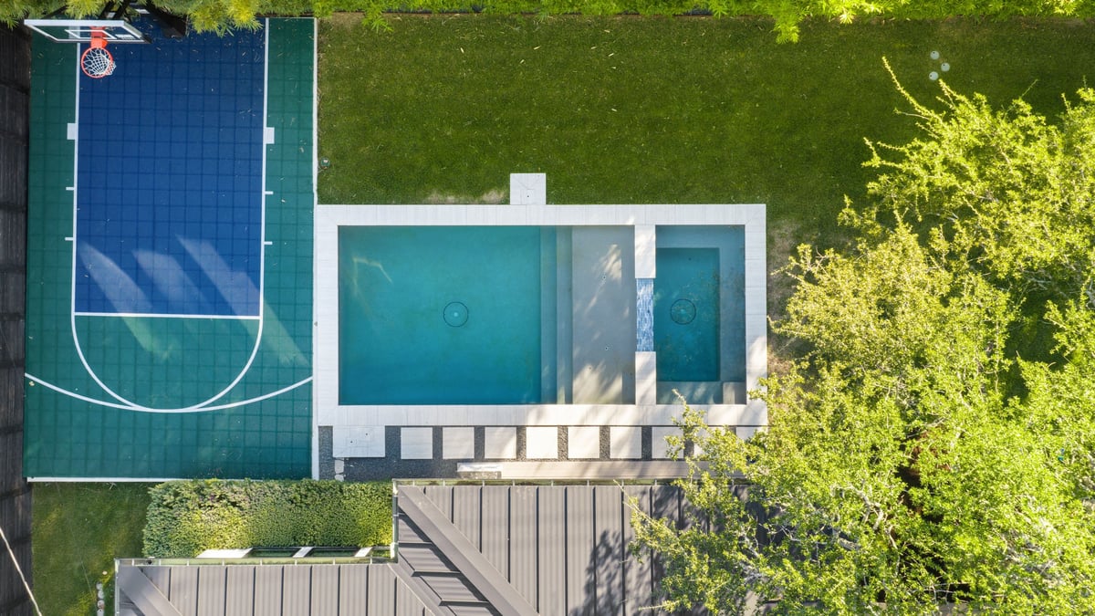Overhead aerial of the basketball court and the pool with its spa