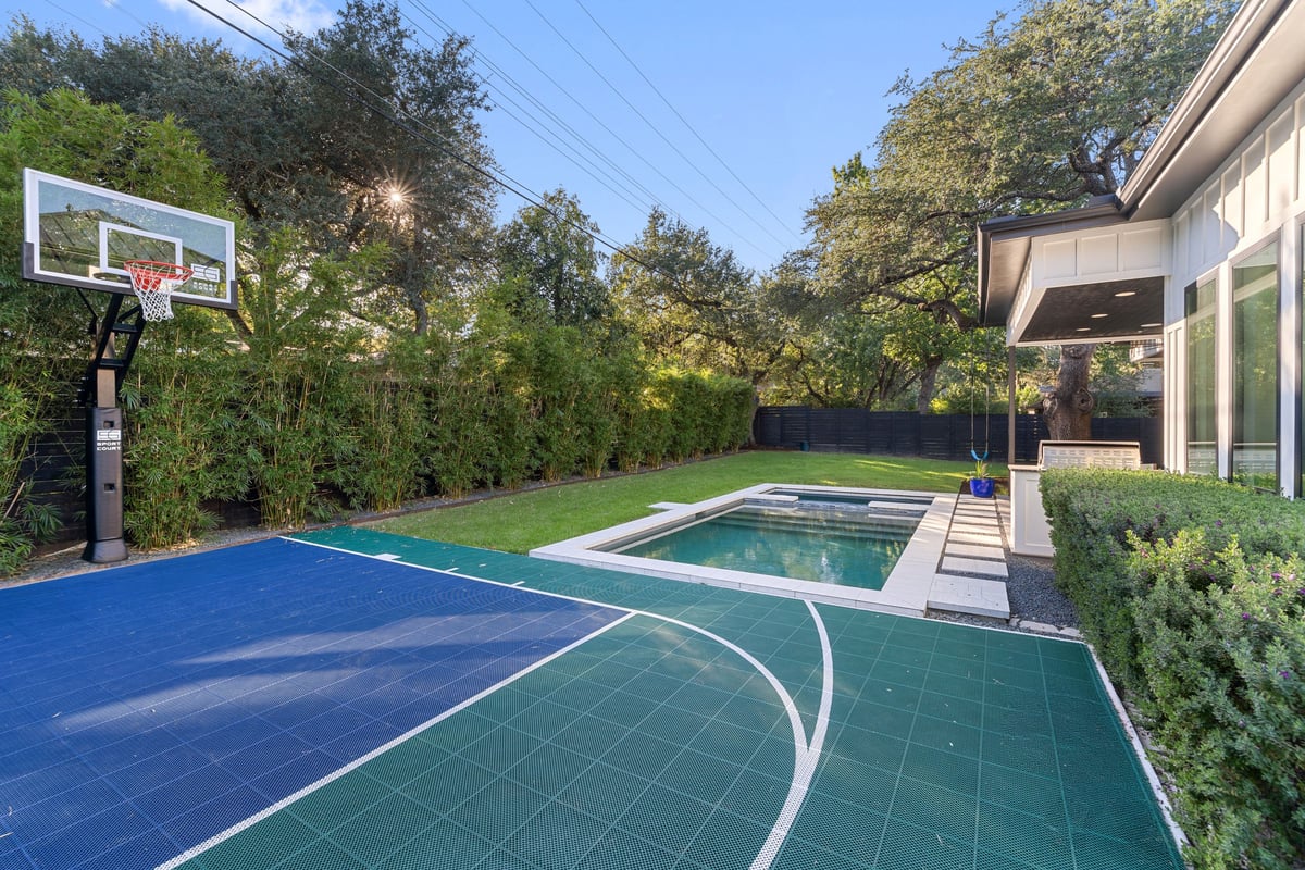 Basketball hoop and court, with the pool beyond