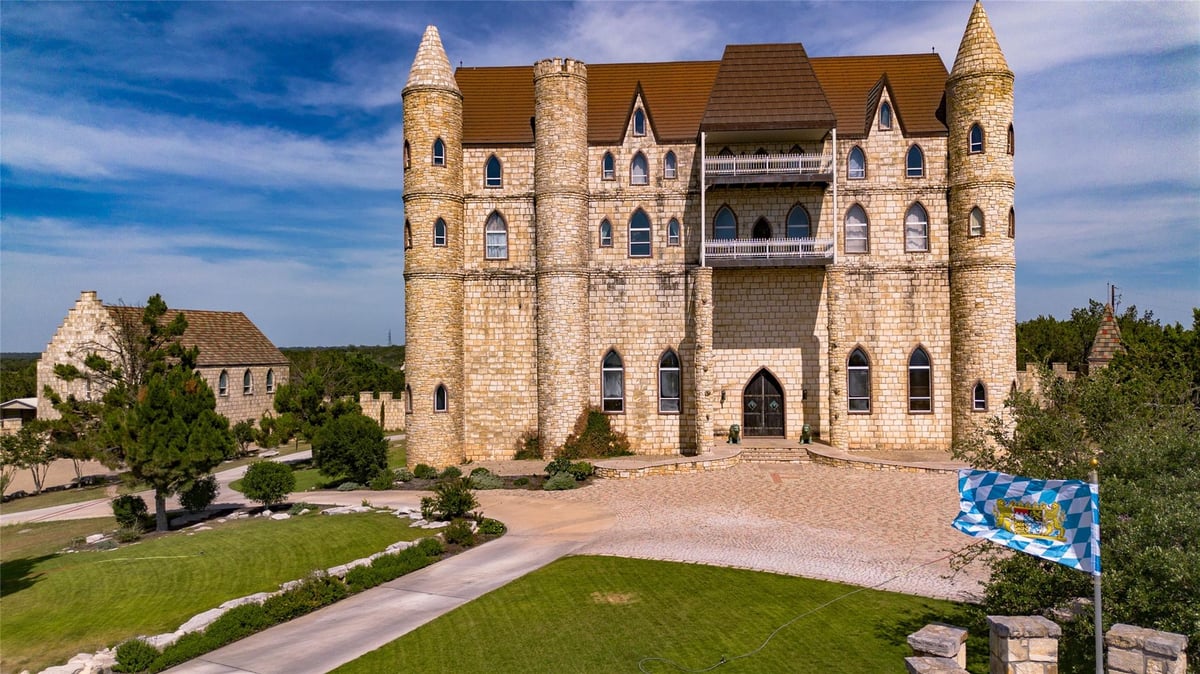 Front exterior with Castle-style architecture at 7400 Park Road 4 S - 7 bed 4 bath home