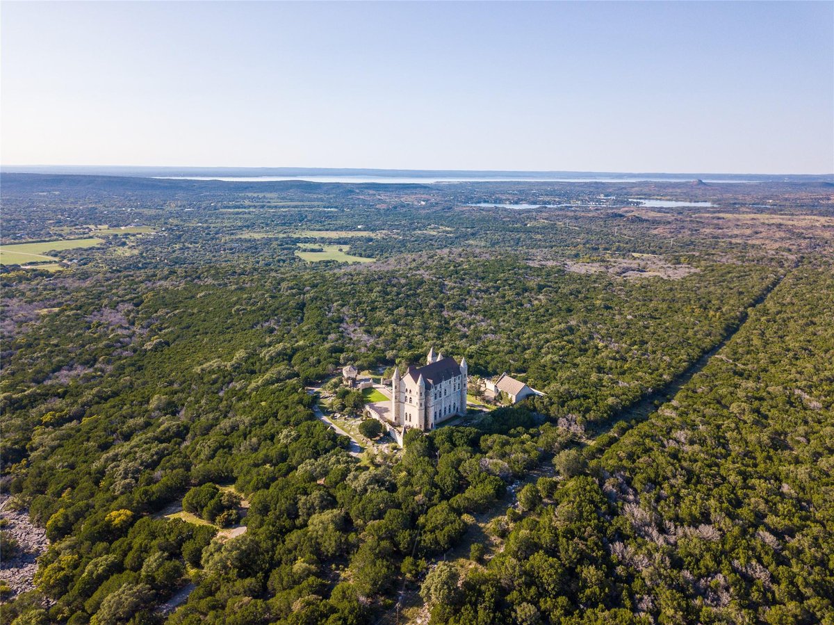Aerial view with European castle architecture at 7400 Park Road 4 S - 7 bed 4 bath home