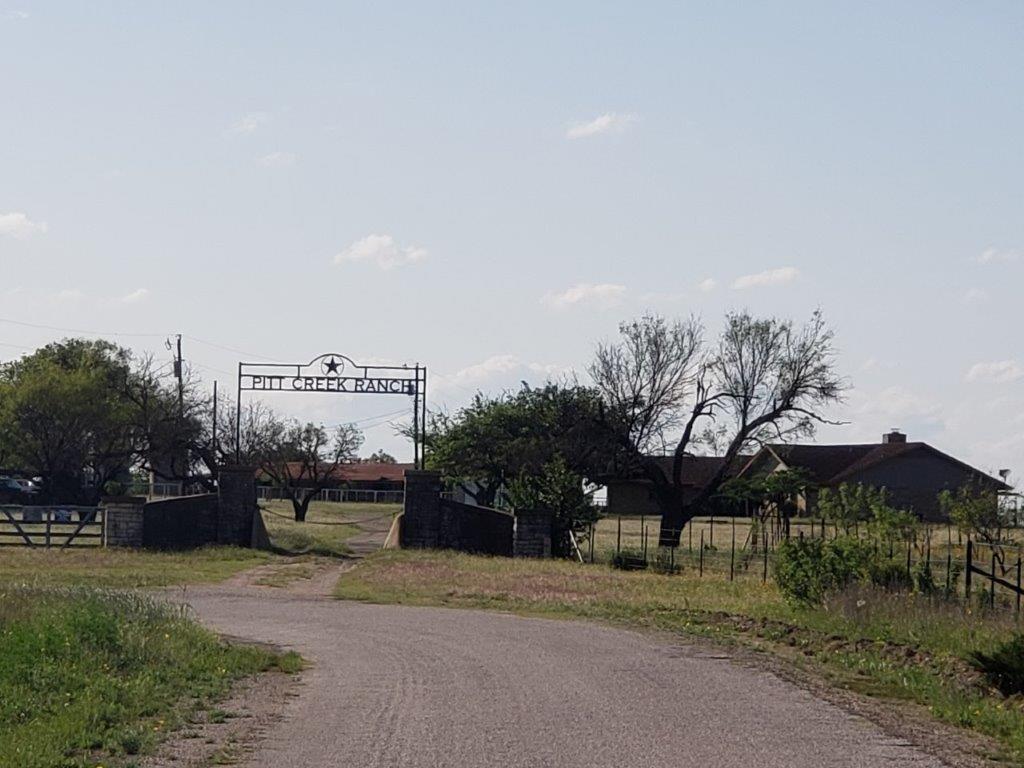 Front exterior with Ranch gate entrance and Acreage property at 7947 County Road 1255 - Lampasas, TX