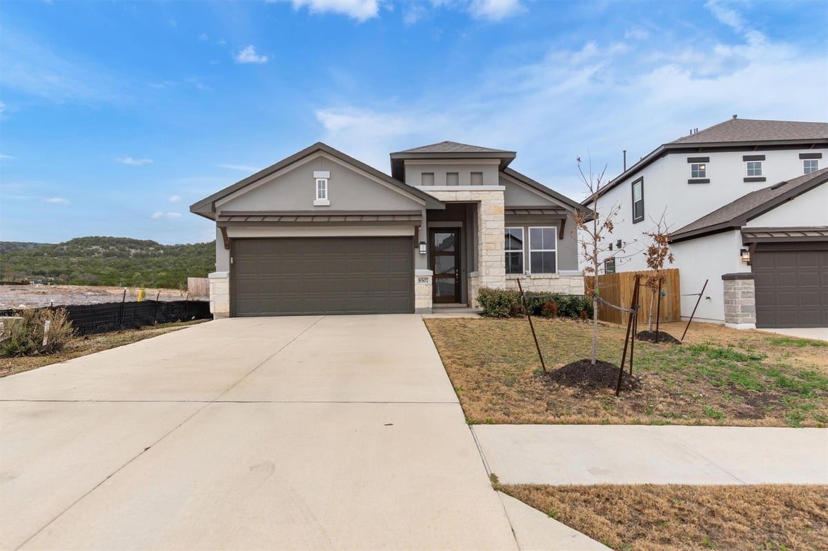 View 8507 Pine Muhly DR in Lakeside at Tessera on Lake Travis 8507 Pine Muhly DR - front exterior - Luxury home in Lakeside at Tessera on Lake Travis, Lago Vista, TX