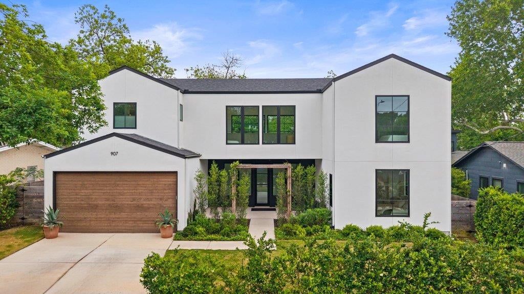View 907 Karen Ave in Violet Crown Heights Sec 01 907 Karen Ave - front exterior with modern white facade and attached garage - Luxury home in Violet Crown Heights Sec 01, ...