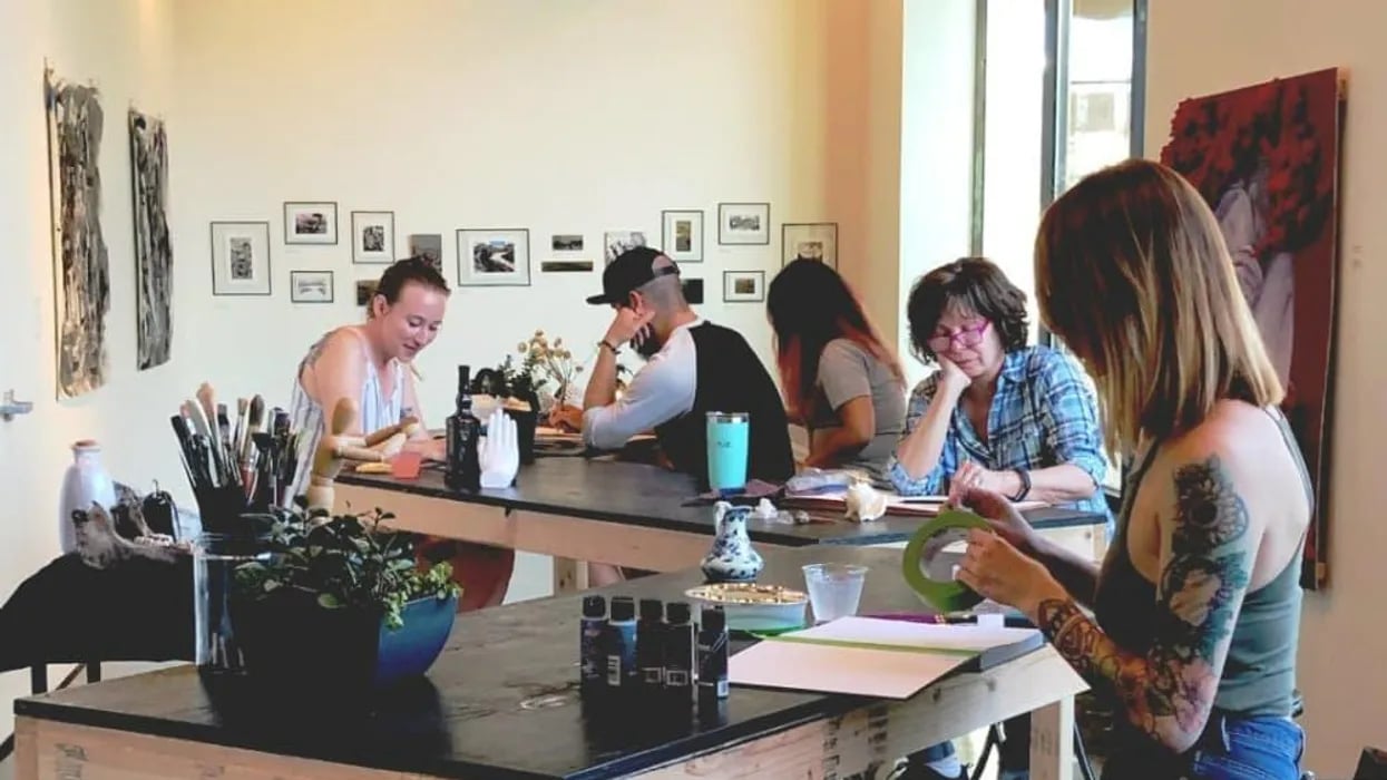 People drawing together at tables in a brewery.