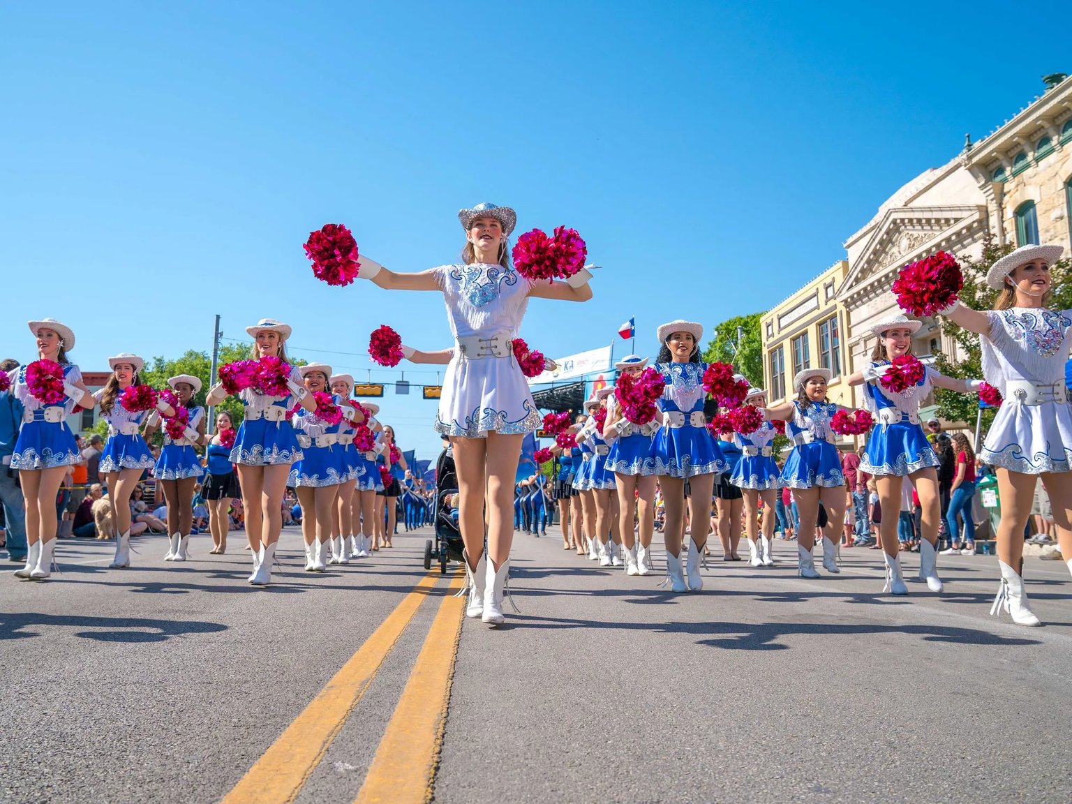 Dancers performing in a street during a festival.