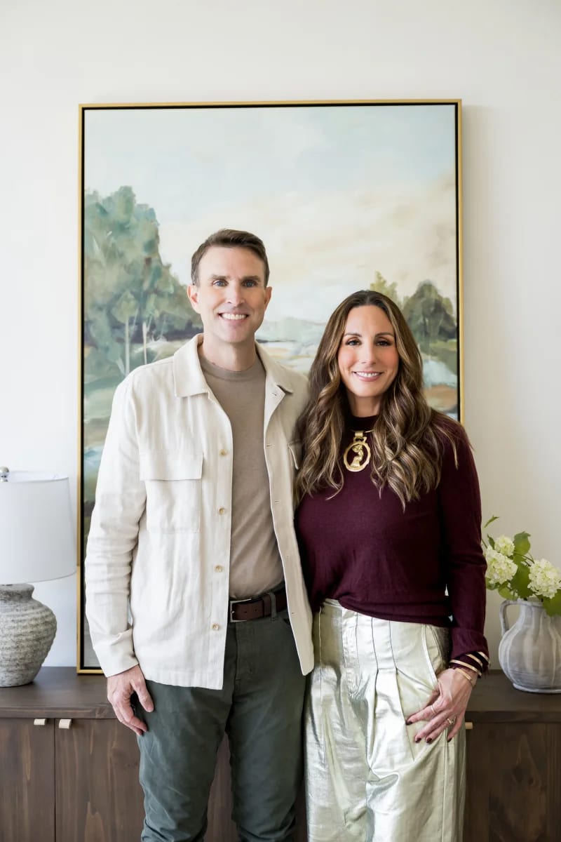Joe and Cara Keenan standing in a living room