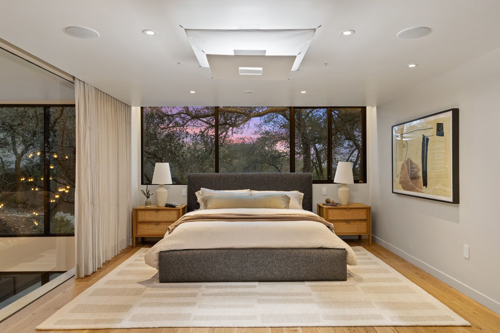 The primary suite opens to the surrounding oaks at 6109 Mountain Villa.