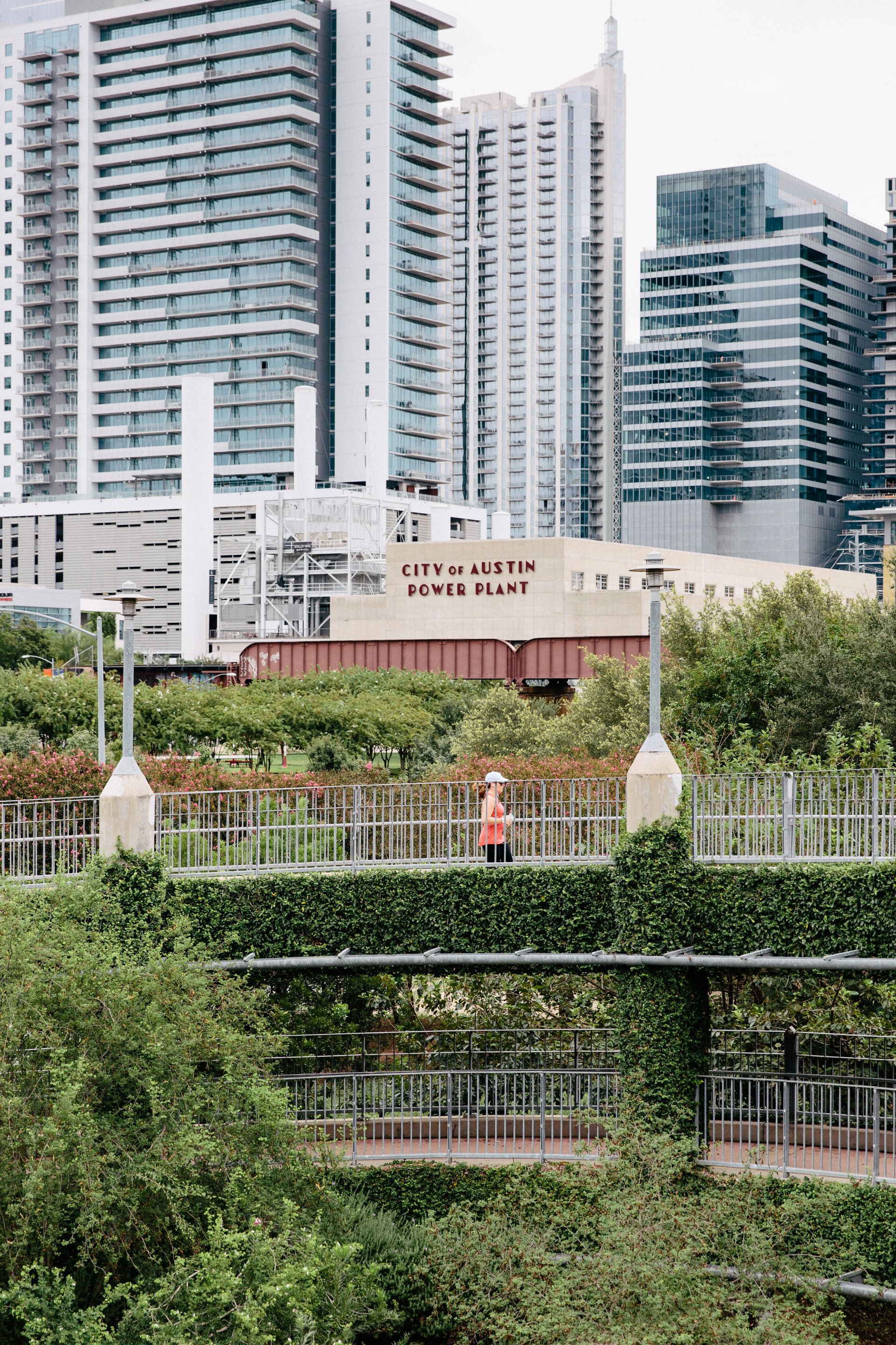 Lady Bird Lake trail boardwalk below downtown high-rises near the Seaholm power plant