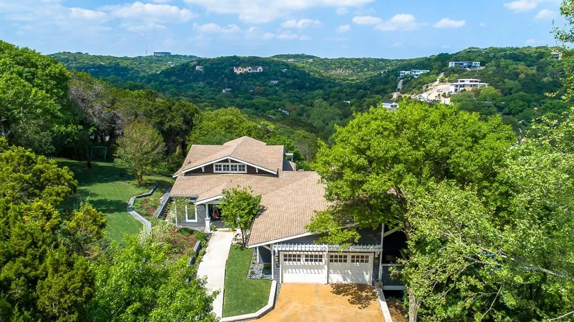 Hill Country Modern estate above Barton Creek fairways with limestone architecture and west Austin terrain representing 78735 luxury real estate.
