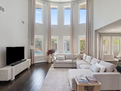 Living area with two-story ceilings and tall windows at 15504 Cabrillo Way - 4 bed 3 bath home