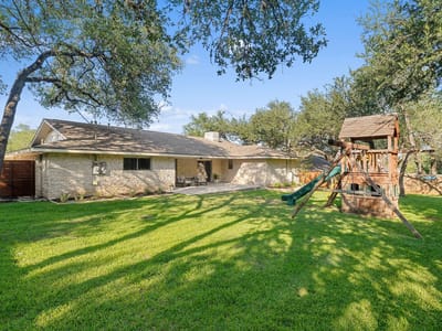 Backyard with mature trees and usable backyard at 4011 Greystone Dr - 4 bed 3 bath home