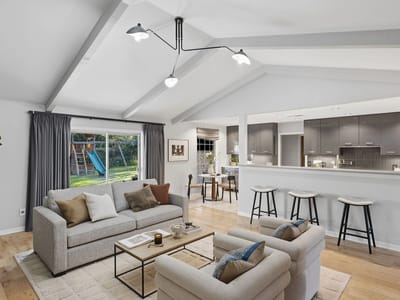 Living area with vaulted ceiling and open kitchen flow at 4011 Greystone Dr - 4 bed 3 bath home