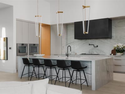Gourmet kitchen with marble waterfall island countertops at 1003 The High Rd - 7 bed 8 bath home