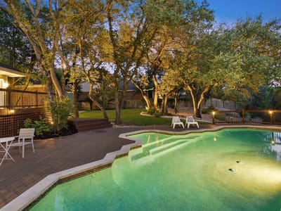 Pool area with twilight lighting and deck at 10038 Circleview DR - 4 bed 3 bath home