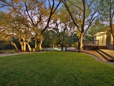 Backyard with mature oaks and deck at 10038 Circleview DR - 4 bed 3 bath home