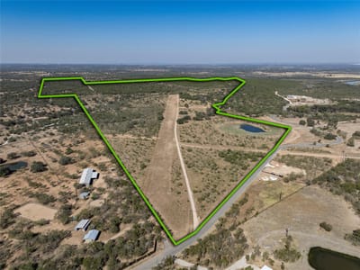 Aerial view - 1033 Flying X Rd Aerial view with expansive acreage with property boundary at 1033 Flying X Rd - Spicewood, TX