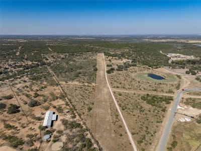 Aerial view - 1033 Flying X Rd Aerial view with private airstrip at 1033 Flying X Rd - Spicewood, TX