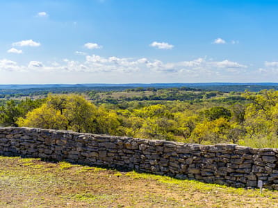 View with dry-stacked stone wall at 1100 Pump Station Rd - none, Wimberley, TX