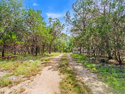 Primary bedroom at 1400 Valley View RD - Burnett Ranch Sec 3, Wimberley, TX