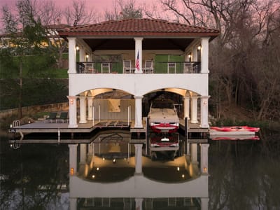 Backyard with two-level boathouse and covered dock at 14500 Flat Top Ranch Rd - 6 bed 6 bath home