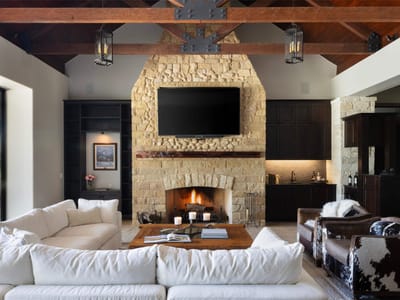 Living area - 15016 Flat Top Ranch Rd Living area with stacked stone fireplace at 15016 Flat Top Ranch Rd - 6 bed 6 bath home