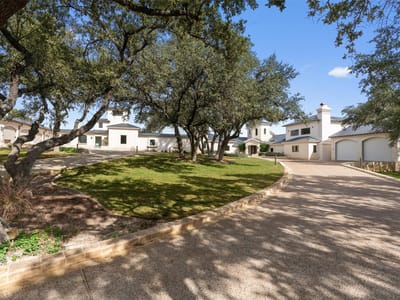 Front exterior with mature oak trees and circular driveway at 26100 Countryside DR - 5 bed 5 bath home
