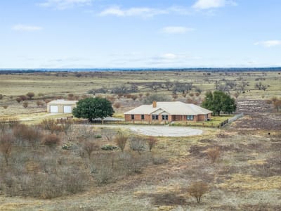Aerial view with sprawling ranch estate at 2884 Political Rd - Lockhart, TX