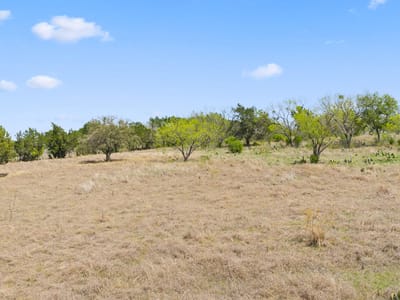 Primary bedroom at 305 Running Brook Trl - Double Horn, Spicewood, TX