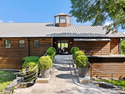 Front exterior with Modern farmhouse architecture at 5055 Wayside Dr - None, Wimberley, TX