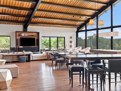 Living area with Floor-to-ceiling glass walls with Hill C at 5055 Wayside Dr - None, Wimberley, TX