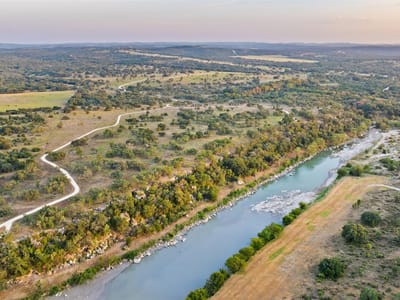 Aerial view with Hill Country river views at 8577 Ranch Road 2766 - 2 bed 1 bath home