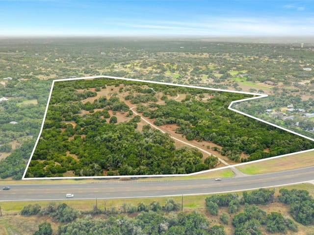 View 1800 E 290 Hwy 1800 E 290 Hwy - front exterior - Luxury home in Dripping Springs, TX