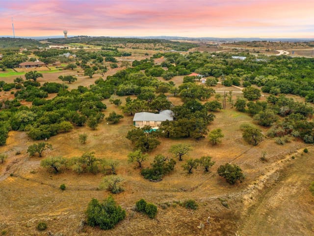 View 1800 E 290 Hwy 1800 E 290 Hwy - front exterior - Luxury home in Dripping Springs, TX