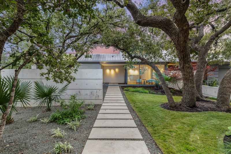 3407 Monte Vista Dr, a concrete walkway under mature live oaks leading to the low-profile modern facade